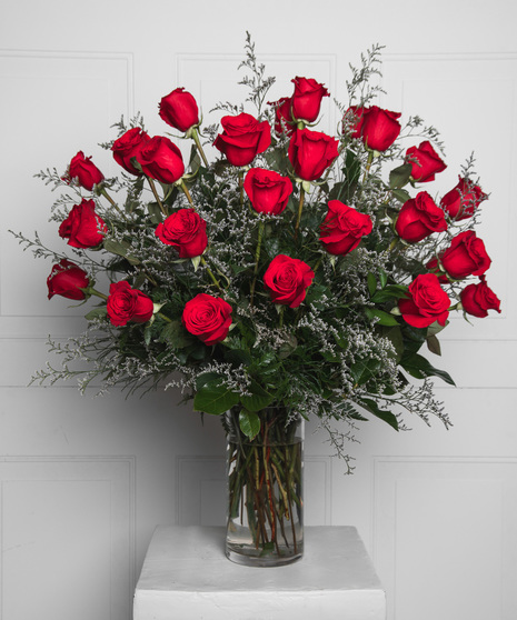 Variations of a medium stem red roses in a glass vase.