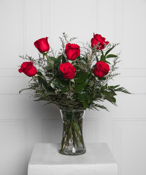 Variations of a medium stem red roses in a glass vase.