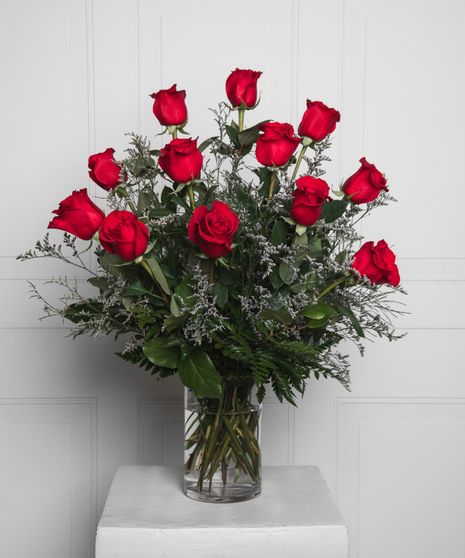 Variations of a medium stem red roses in a glass vase.