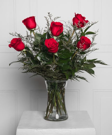 Variations of a medium stem red roses in a glass vase.