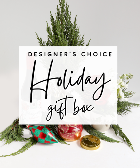 A curated box full of fresh holiday gifts including ornaments, a holiday plant, holiday-inspired candles, and other floral and plant products filled to value.