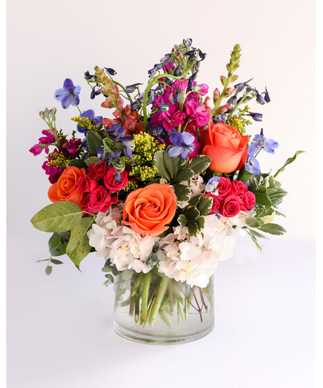 Born to be Wild is a vibrant fusion of hot pink and orange blooms designed to ignite joy and celebrate birthdays with flair. 