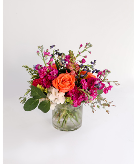 Born to be Wild is a vibrant fusion of hot pink and orange blooms designed to ignite joy and celebrate birthdays with flair. 