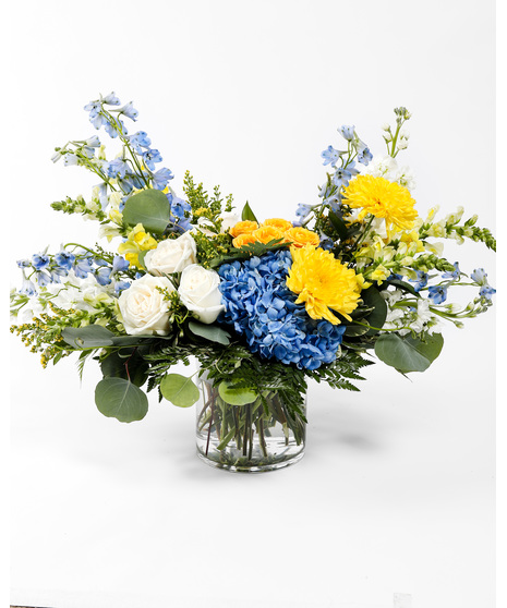 Cheerful Sunshine is a vibrant blend of yellow and blue blooms crafted to uplift spirits and convey warm wishes.