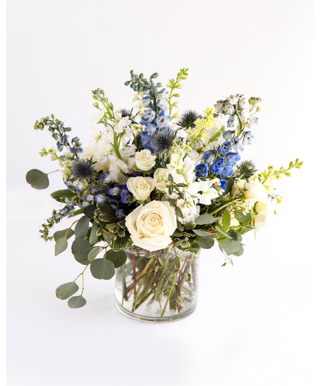 The Heavenly Arrangement is a breathtakingly beautiful arrangement that exudes a sense of peace and tranquility with blue and white florals.