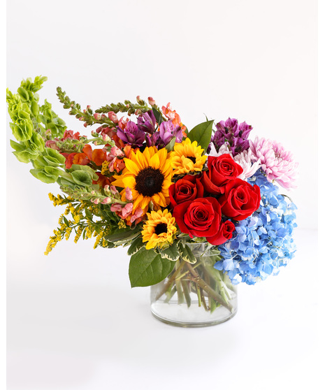 Flirty 30s boasts a beautiful blend of colorful roses, sunflowers, cremones, and hydrangeas, with each flower completing the other perfectly. 